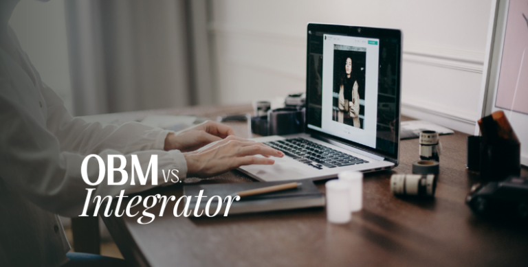 Picture of hands typing on laptop keyboard with the words OBM vs. Integrator overlaid on top